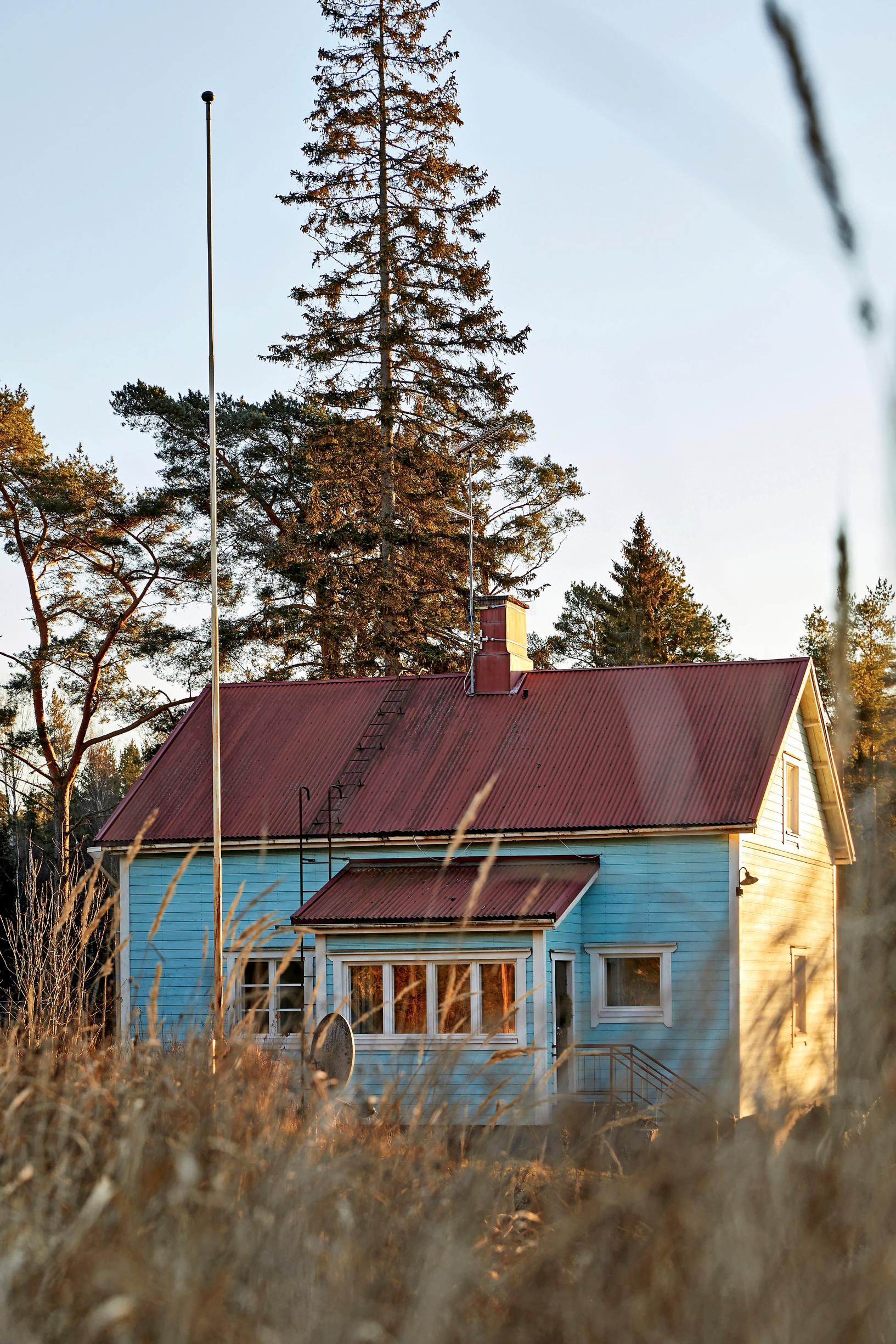 Sininen talo metsämaisemassa