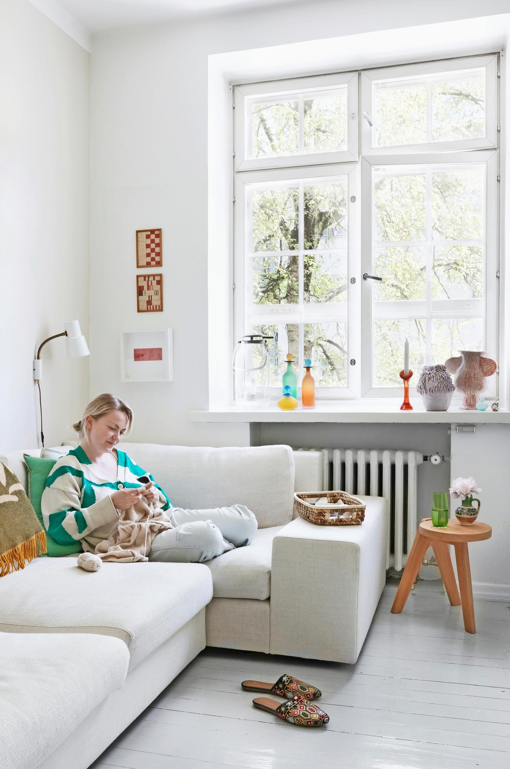 Emilia sohvalla ruutuikkunan alla