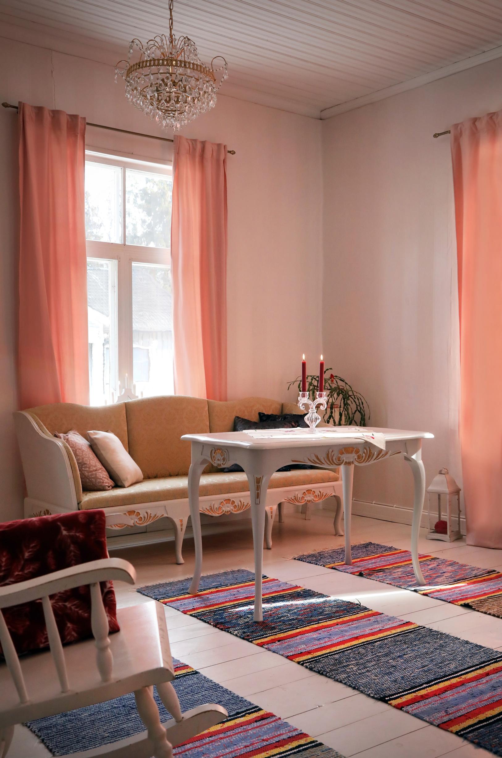 Vanha, koristeellinen puusohva ikkunan edustalla