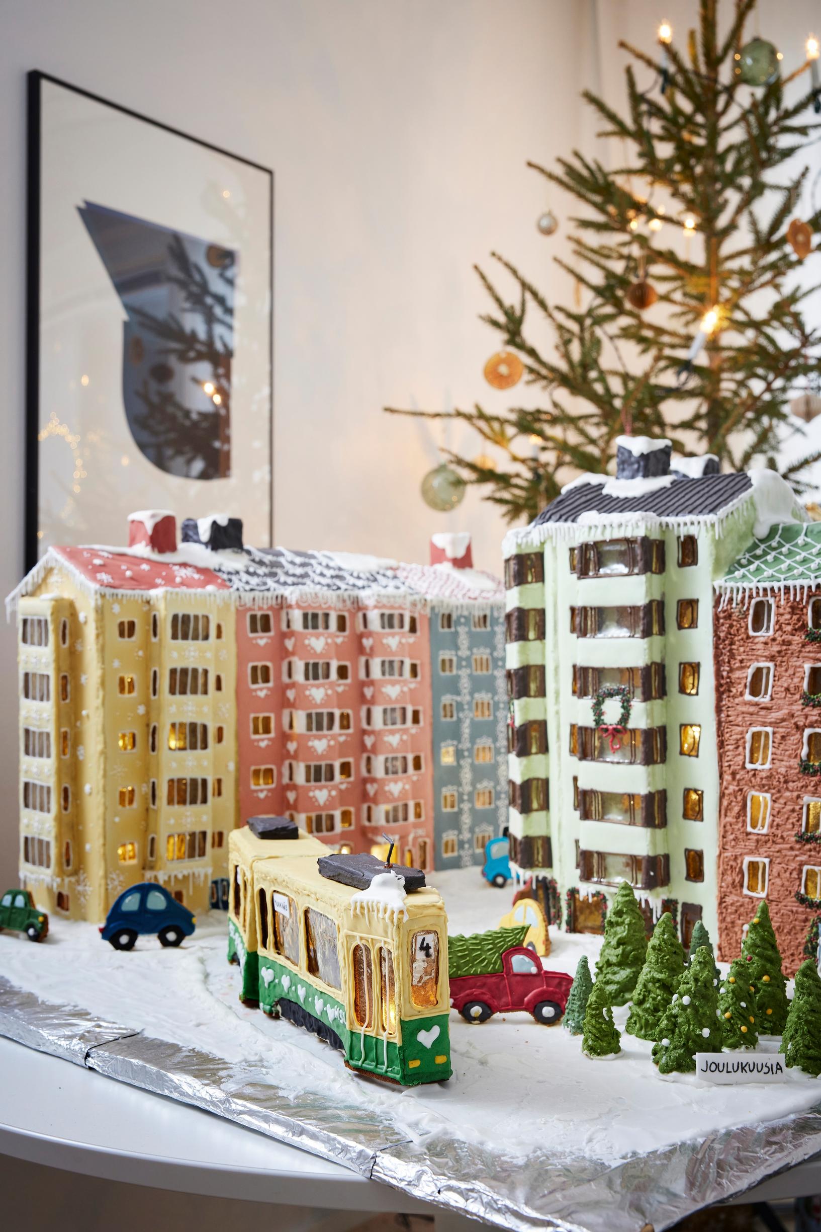 Töölöstä inpiraationsa saanut piparikortteli, erivärisiä kerrostaloja ja keskellä ratikka.