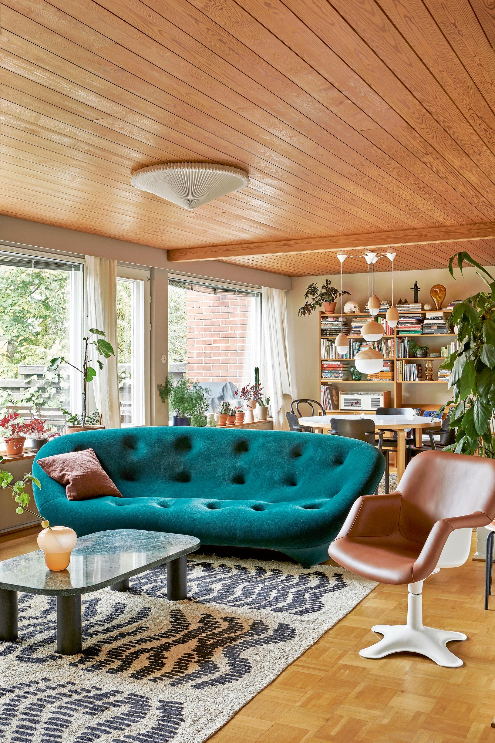 Olohuone ja ruokailutila ovat yhtä avaraa tilaa, josta aukeaa näkymä pihalle. Keskipisteenä Ligne Roset’n Ploum-sohva